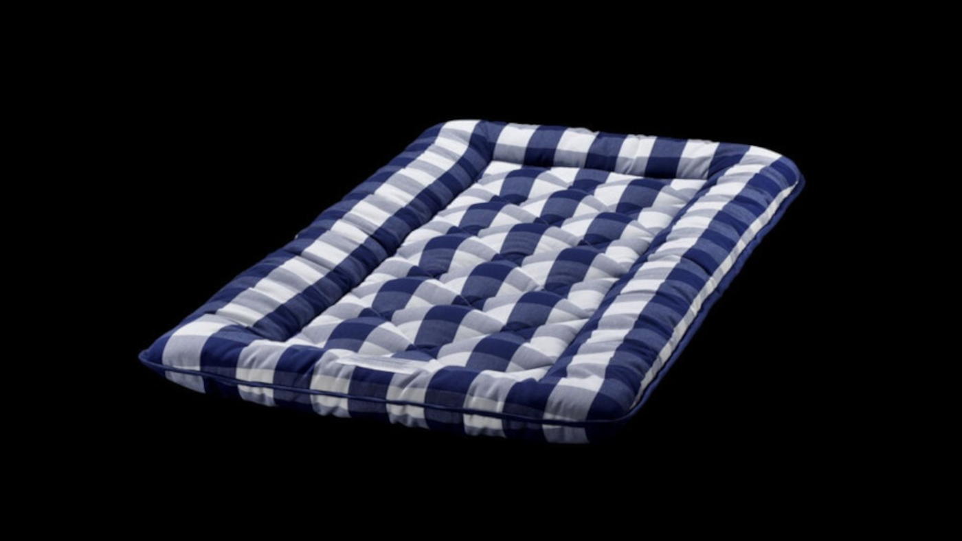 Blue and white striped cushioned mat with a quilted, rectangular shape on a black background.